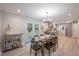 Dining room featuring a wooden table with bar cart, and backyard access via french doors at 7993 Malden Ave, North Charleston, SC 29420
