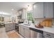 Bright kitchen features stainless steel appliances, gray cabinets, and quartz countertops at 7993 Malden Ave, North Charleston, SC 29420