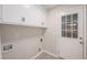 Practical laundry room features white cabinets and door to the exterior at 7993 Malden Ave, North Charleston, SC 29420