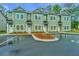 Lovely green townhome featuring tidy landscaping, individual entrances, and parking space at 803 Twin Rivers Dr, Wando, SC 29492