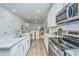 Modern kitchen featuring stainless appliances, granite counters, and open layout to the dining area at 803 Twin Rivers Dr, Wando, SC 29492