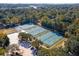 Overhead view of tennis and volleyball courts surrounded by lush trees within a community at 810 Creekside Dr, Mount Pleasant, SC 29464