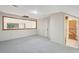 A spacious basement area with carpeting, a view into another room, and access to stairs at 810 Creekside Dr, Mount Pleasant, SC 29464