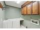 Accessible bathroom featuring a walk-in bathtub, wooden cabinets, and light green walls at 810 Creekside Dr, Mount Pleasant, SC 29464
