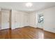 A bright bedroom featuring hardwood floors, white walls, and a single window at 810 Creekside Dr, Mount Pleasant, SC 29464