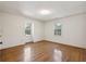 A bright bedroom with hardwood floors and two windows providing natural light at 810 Creekside Dr, Mount Pleasant, SC 29464