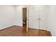 A light-filled bedroom with hardwood floors and an opened doorway to floral wallpapered stairs at 810 Creekside Dr, Mount Pleasant, SC 29464
