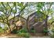 Unique home with brick and siding elements, complemented by mature trees and verdant landscaping at 810 Creekside Dr, Mount Pleasant, SC 29464