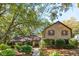 Charming brick home with mature trees and manicured landscaping creates a welcoming curb appeal at 810 Creekside Dr, Mount Pleasant, SC 29464