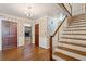 Charming foyer featuring hardwood floors, floral wallpaper, and staircase at 810 Creekside Dr, Mount Pleasant, SC 29464