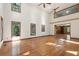 Large living room with vaulted ceiling, hardwood floors, and multiple windows offering natural light and scenic views at 810 Creekside Dr, Mount Pleasant, SC 29464