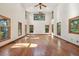 Bright, airy living room with soaring ceilings, large windows, and hardwood floors at 810 Creekside Dr, Mount Pleasant, SC 29464