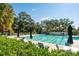Community pool and lounging chairs with umbrellas perfect for enjoying the outdoors at 810 Creekside Dr, Mount Pleasant, SC 29464