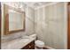 Elegant powder room with granite countertop, decorative mirror, and modern lighting at 810 Creekside Dr, Mount Pleasant, SC 29464