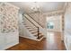 View of a staircase with hardwood floors, floral wallpaper, and white trim at 810 Creekside Dr, Mount Pleasant, SC 29464
