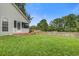 Grassy backyard with partial fence, deck, and screened porch at 8524 Brookforest Dr, Charleston, SC 29406