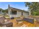 The outdoor deck features wicker furniture, a screened-in porch, and solar panels visible on the house roof at 8524 Brookforest Dr, Charleston, SC 29406