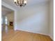 Dining room featuring chandelier lighting, access to living area with fireplace, and wood flooring at 8524 Brookforest Dr, Charleston, SC 29406