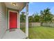 Inviting front porch with vibrant red door, hanging plants, and clear view of the house number at 8524 Brookforest Dr, Charleston, SC 29406
