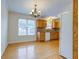 Kitchen dining area featuring wood floors, chandelier, wooden cabinetry and large window at 8524 Brookforest Dr, Charleston, SC 29406