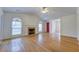 Inviting living room with hardwood floors, fireplace, natural light, and a charming red door at 8524 Brookforest Dr, Charleston, SC 29406