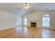 Cozy living room with hardwood floors, fireplace, vaulted ceiling, and an abundance of natural light at 8524 Brookforest Dr, Charleston, SC 29406