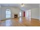 Bright living room with hardwood floors, fireplace, neutral walls, and large arched windows at 8524 Brookforest Dr, Charleston, SC 29406