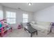 Bright bonus bedroom with natural light, a couch, a table, and toys at 9767 Black Willow Ln, Ladson, SC 29456