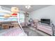 bedroom with bunkbeds, shelving, window, a pink chair, and carpeted flooring at 9767 Black Willow Ln, Ladson, SC 29456