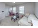 Cozy bonus bedroom area with a couch, two windows, and carpeted flooring at 9767 Black Willow Ln, Ladson, SC 29456