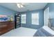 Cozy bedroom with hardwood furniture, light, two windows, and white ceiling fan at 9767 Black Willow Ln, Ladson, SC 29456