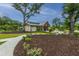 Charming community center featuring stone accents, lush landscaping, and inviting outdoor space at 9767 Black Willow Ln, Ladson, SC 29456