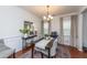 Elegant dining room featuring a stylish table set, hardwood floors, and natural light from the windows at 9767 Black Willow Ln, Ladson, SC 29456