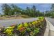 Beautifully landscaped community entrance featuring colorful flowers and an elegant water feature at 9767 Black Willow Ln, Ladson, SC 29456