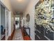 Welcoming entryway with hardwood floors, a stylish console table, and a view into the adjoining living spaces at 9767 Black Willow Ln, Ladson, SC 29456
