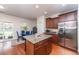 This kitchen features stainless steel appliances, a kitchen island and a breakfast area at 9767 Black Willow Ln, Ladson, SC 29456