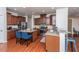 Modern kitchen with granite countertops, stainless steel appliances, rich wood cabinets, and a breakfast bar at 9767 Black Willow Ln, Ladson, SC 29456
