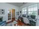 Bright office space with French doors, a desk setup, and two large windows offering ample light at 9767 Black Willow Ln, Ladson, SC 29456
