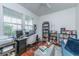 Functional home office with a large desk, shelving, and plenty of natural light, ideal for remote work at 9767 Black Willow Ln, Ladson, SC 29456