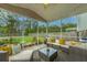 Inviting screened patio featuring comfortable seating, stylish decor, and a serene backyard view at 9767 Black Willow Ln, Ladson, SC 29456