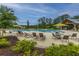 Community pool with lounge chairs, umbrellas, and a covered pavilion, perfect for relaxation and recreation at 9767 Black Willow Ln, Ladson, SC 29456