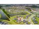 Aerial shot showing a residential community with ponds, lush landscaping, and a swimming pool at 102 Bolsena Ct, Summerville, SC 29486