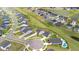 Aerial view of a residential neighborhood with well-maintained homes, landscaping, and a nearby pond at 102 Bolsena Ct, Summerville, SC 29486