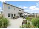 Backyard view showcasing a covered patio area, outdoor dining furniture, and manicured landscaping at 102 Bolsena Ct, Summerville, SC 29486
