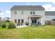 Spacious backyard featuring a covered patio, outdoor seating, lush grass, and a well-maintained lawn at 102 Bolsena Ct, Summerville, SC 29486
