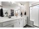 Modern bathroom with double vanity, black hardware, and walk-in shower featuring a built-in bench at 102 Bolsena Ct, Summerville, SC 29486