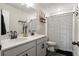 Elegant bathroom with dual vanities, quartz countertops, and a shower with a striped curtain at 102 Bolsena Ct, Summerville, SC 29486