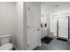 Bathroom features a toilet, vanity with dual sinks, and a glass-enclosed shower with black accents at 102 Bolsena Ct, Summerville, SC 29486