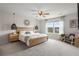 Inviting bedroom with a natural wood bed frame, stylish lamps, and sun-filled windows at 102 Bolsena Ct, Summerville, SC 29486