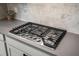 Modern stainless steel Whirlpool cooktop with gray countertops and stylish backsplash at 102 Bolsena Ct, Summerville, SC 29486
